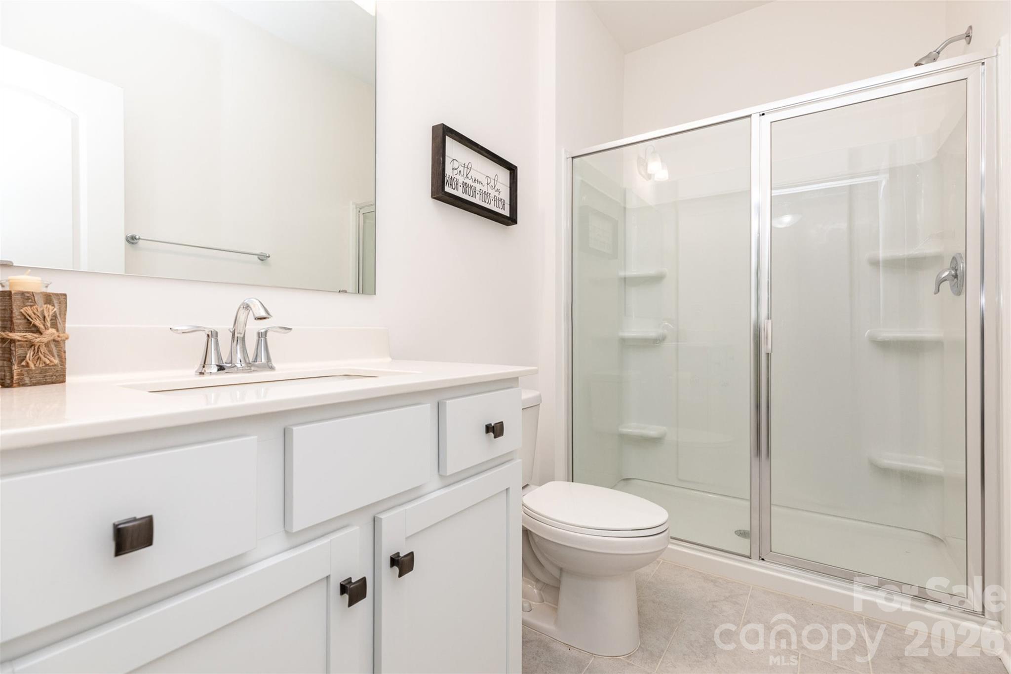 948 Scotch Meadows Loop Monroe, NC 28110 - Photo 22 of 25 a bathroom with a shower sink vanity mirror and toilet