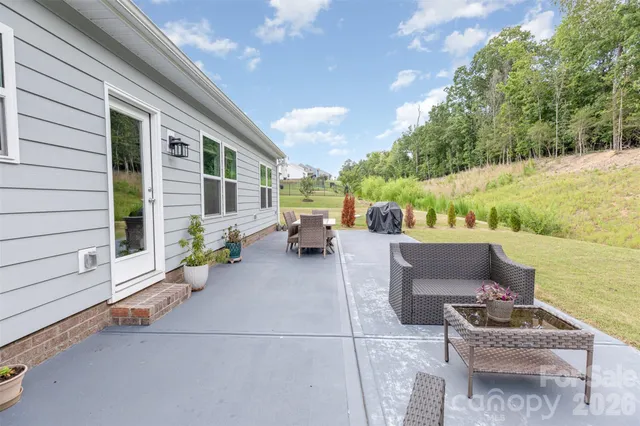 a backyard of a house with outdoor seating