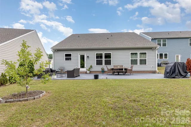 a view of a house with swimming pool and sitting area