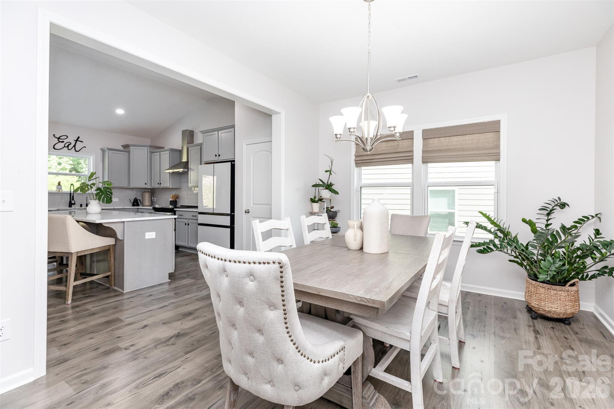 948 Scotch Meadows Loop Monroe, NC 28110 - Photo 4 of 25 a dining room with furniture potted plants and wooden floor