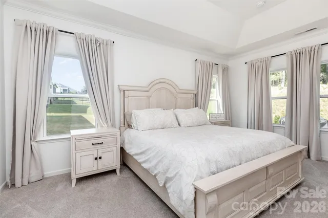 a bedroom with a bed and a large window