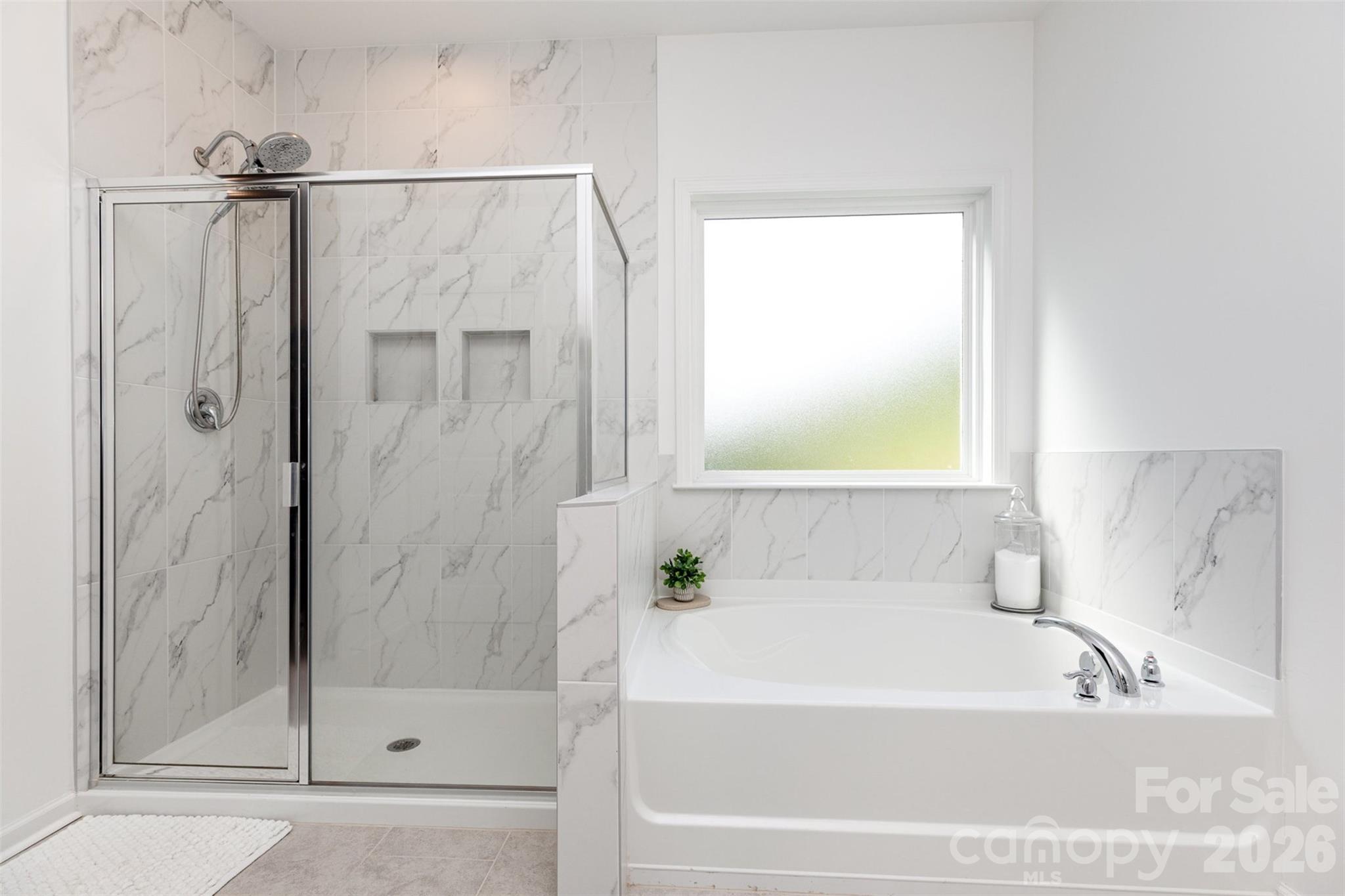 948 Scotch Meadows Loop Monroe, NC 28110 - Photo 6 of 25 a bathroom with a bathtub and a shower