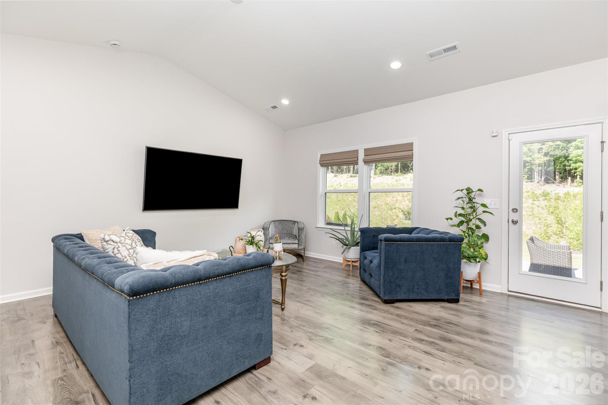 948 Scotch Meadows Loop Monroe, NC 28110 - Photo 10 of 25 a living room with furniture and a flat screen tv