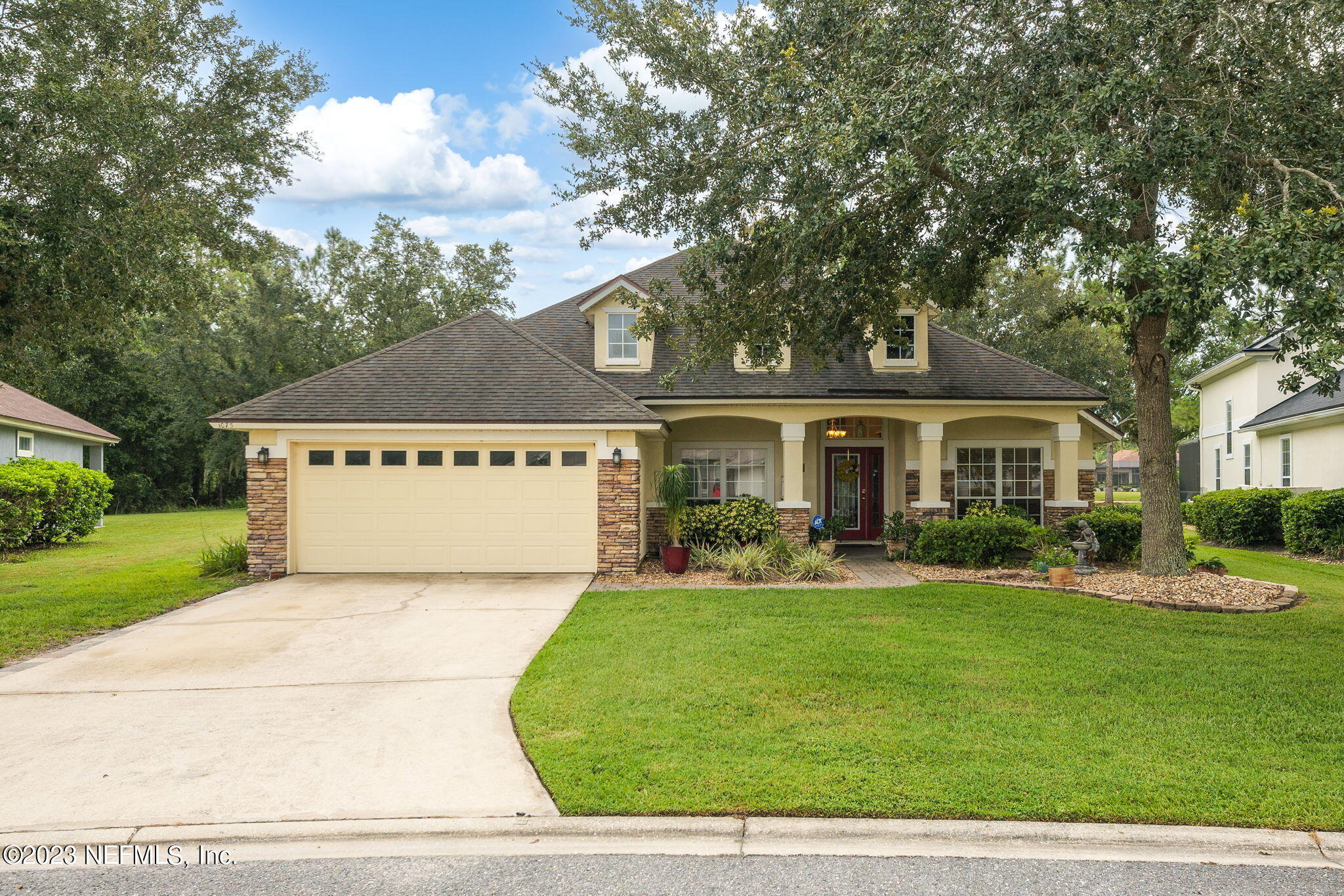 a front view of a house with garden
