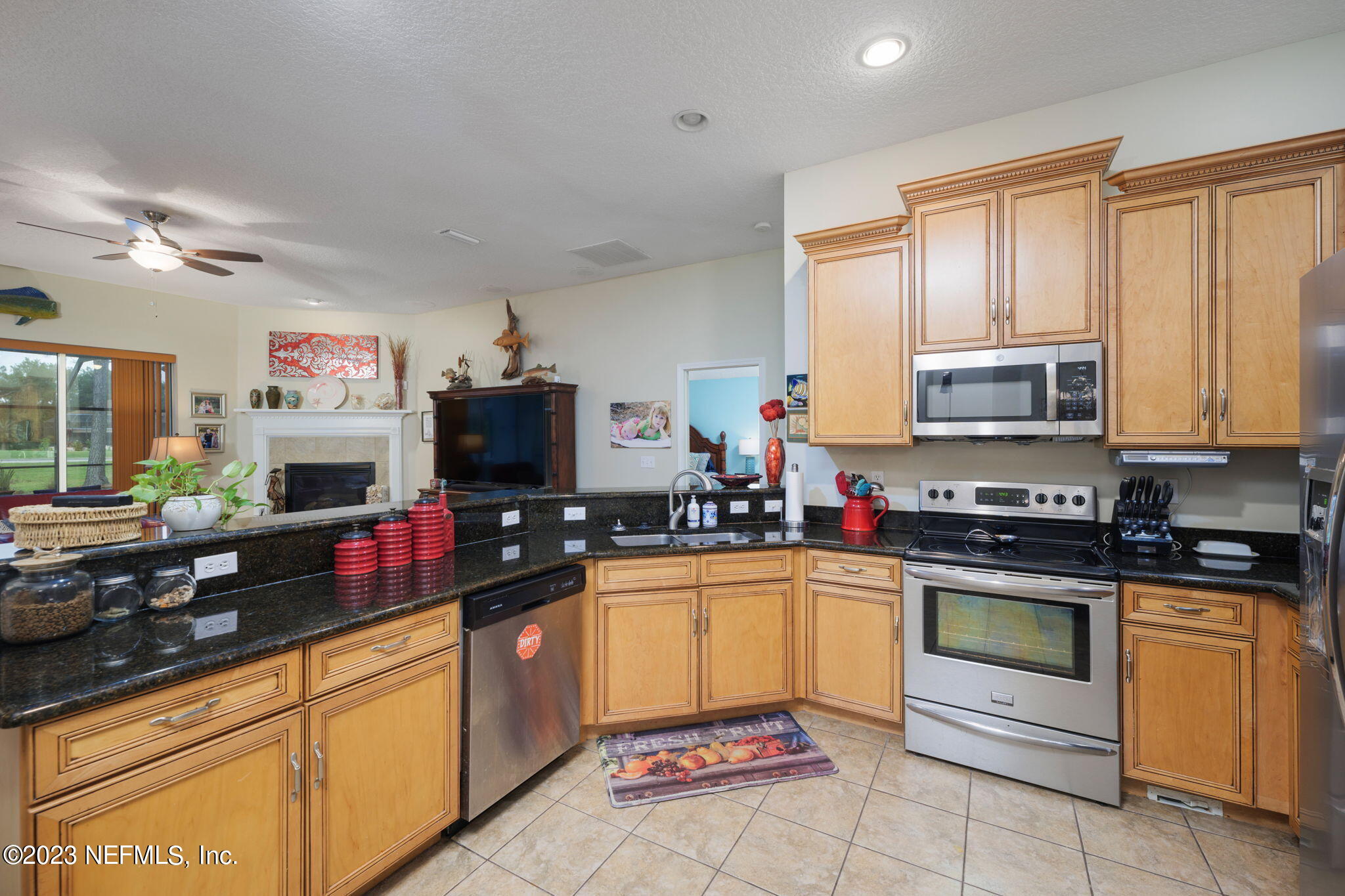 1075 Green Pine Circle Orange Park, FL 32065 - Photo 13 of 35 a kitchen with stainless steel appliances granite countertop a stove sink and microwave