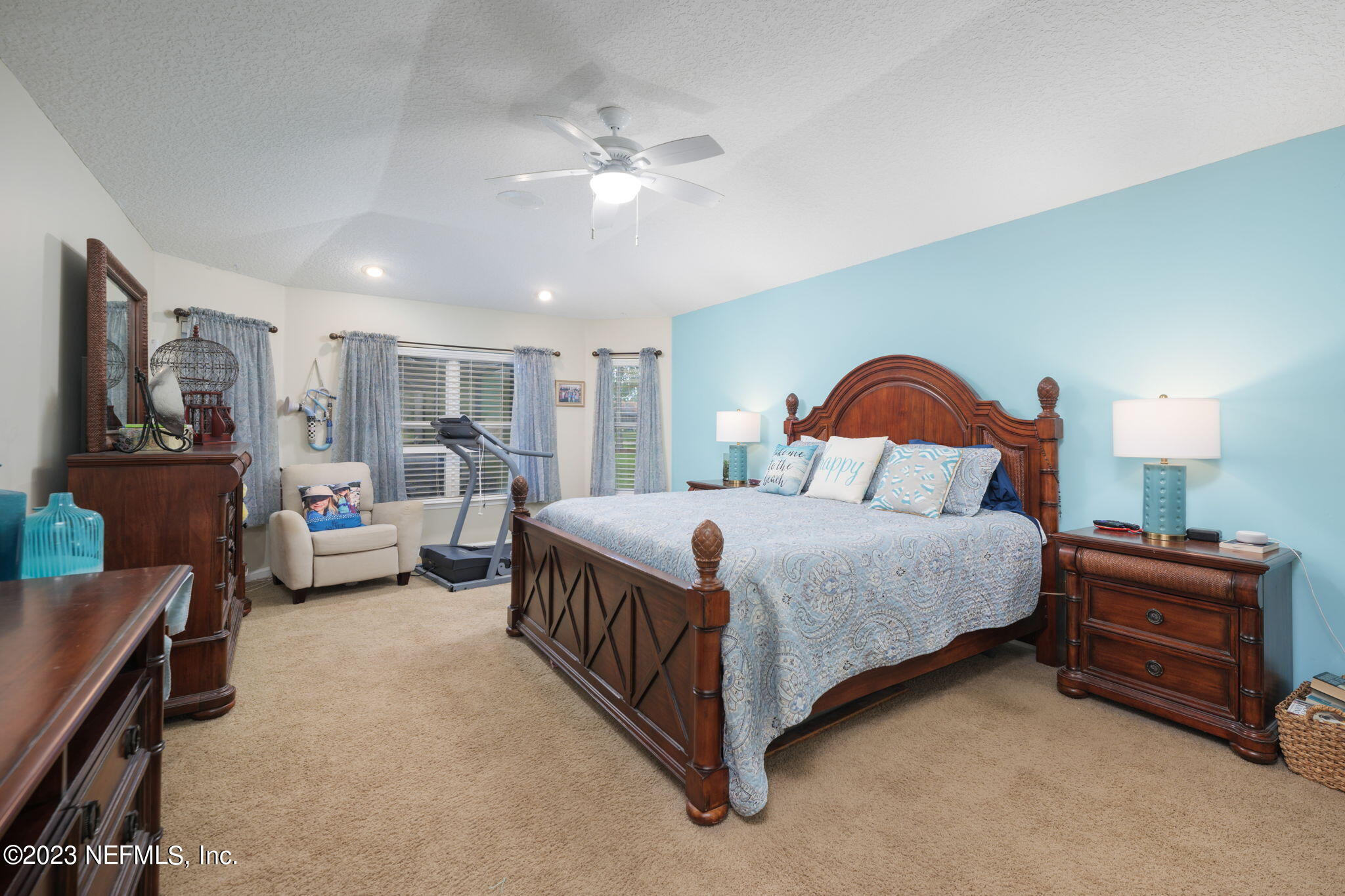 1075 Green Pine Circle Orange Park, FL 32065 - Photo 14 of 35 a bedroom with a bed and a chandelier