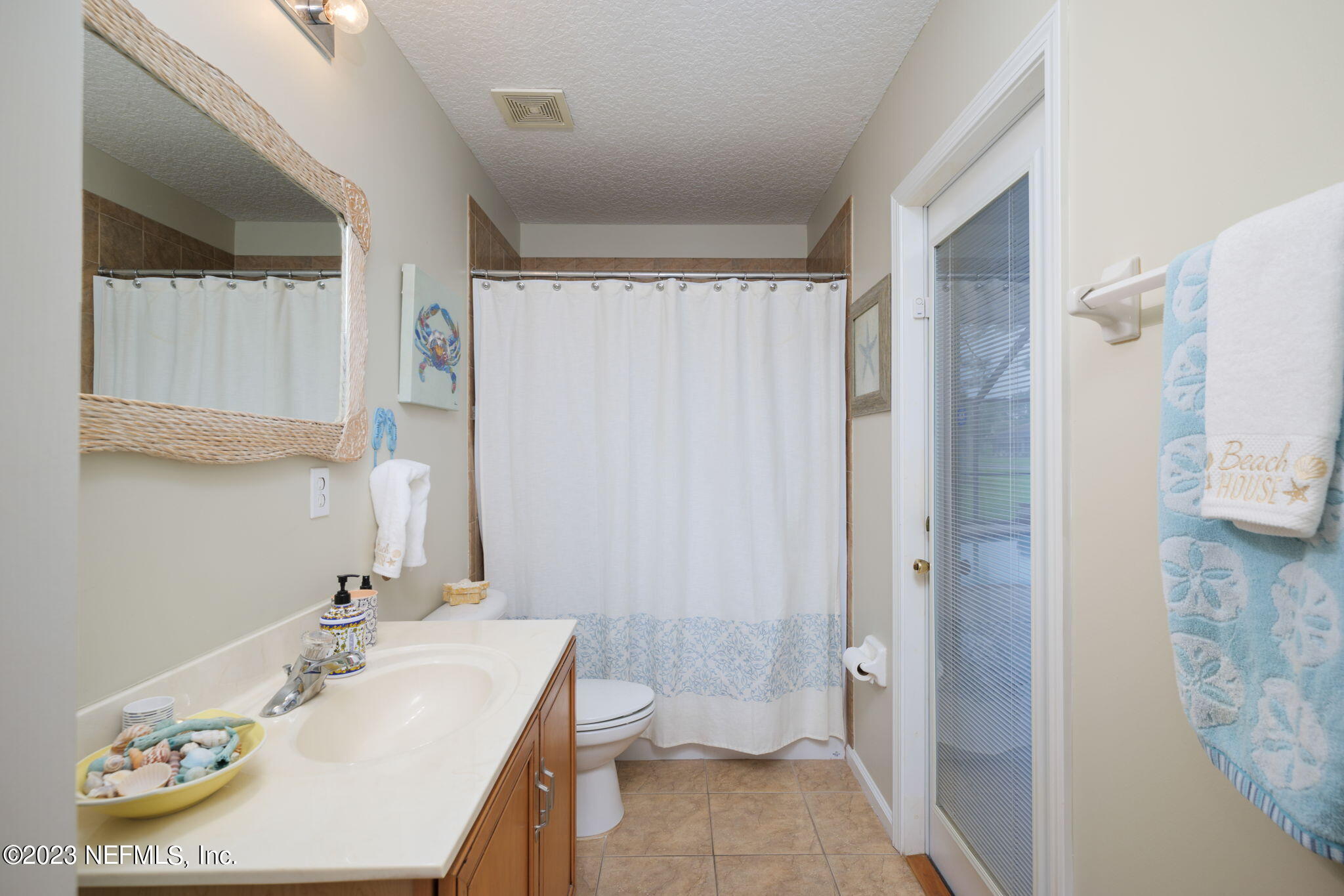 1075 Green Pine Circle Orange Park, FL 32065 - Photo 18 of 35 a bathroom with a sink a toilet and shower curtain