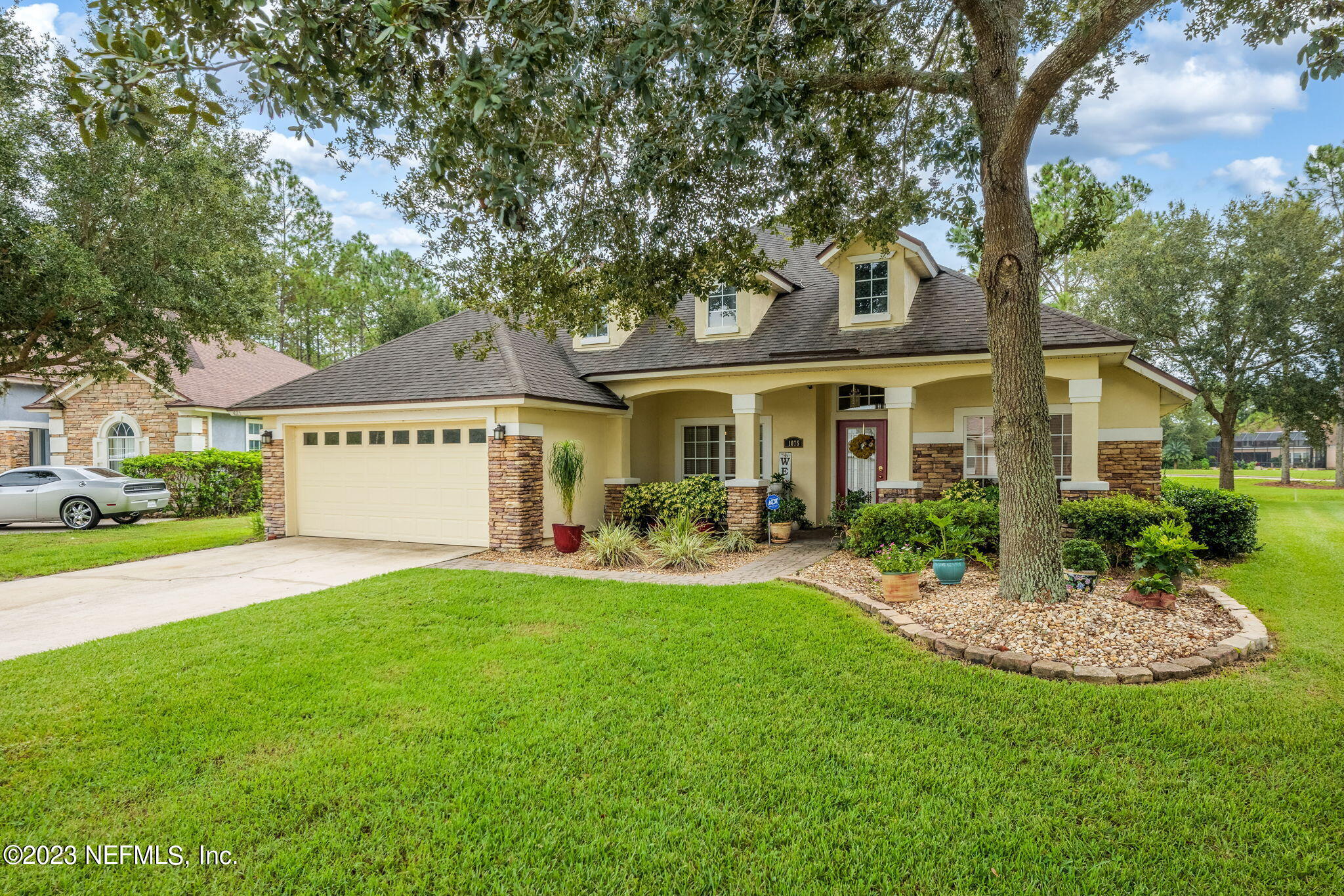 1075 Green Pine Circle Orange Park, FL 32065 - Photo 2 of 35 a view of a house with a yard porch and a table and chairs