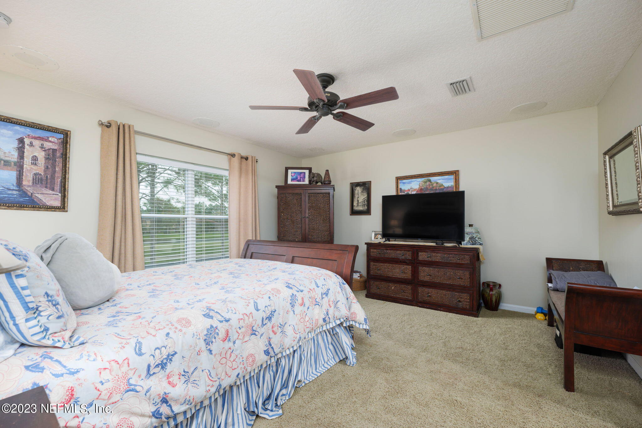 1075 Green Pine Circle Orange Park, FL 32065 - Photo 24 of 35 a bedroom with a bed and a flat screen tv