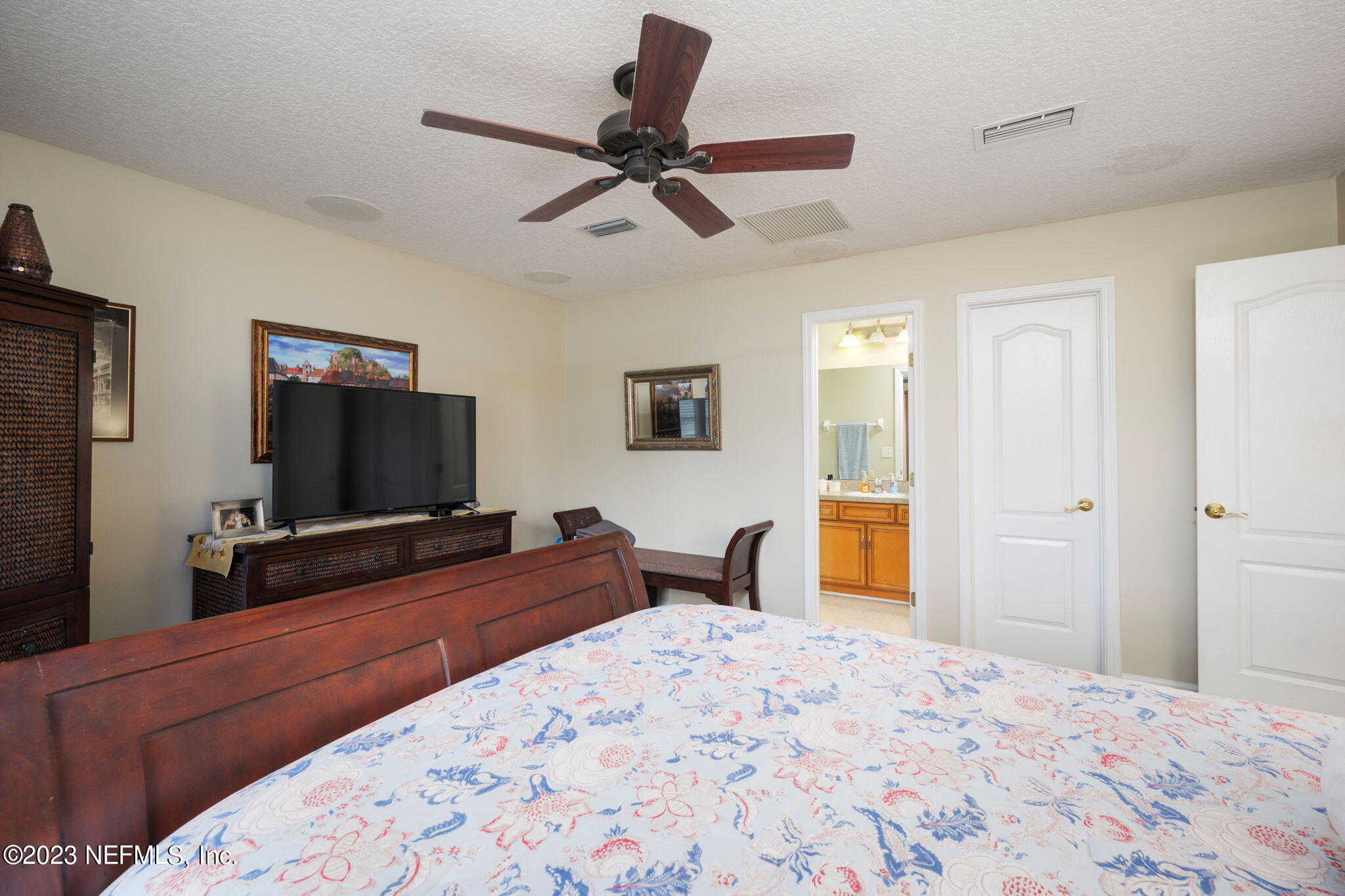 1075 Green Pine Circle Orange Park, FL 32065 - Photo 25 of 35 a bedroom with a bed and a flat screen tv