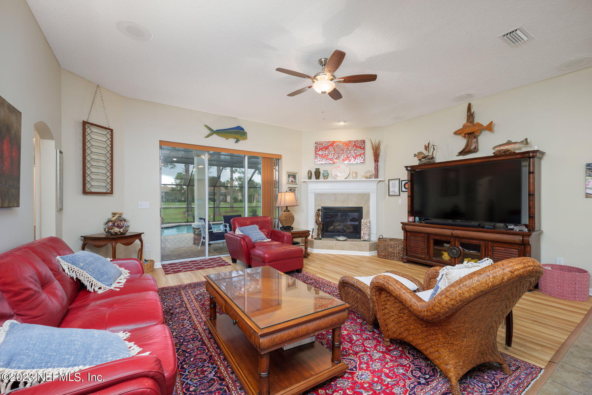 1075 Green Pine Circle Orange Park, FL 32065 - Photo 8 of 35 a living room with furniture a flat screen tv and a fireplace