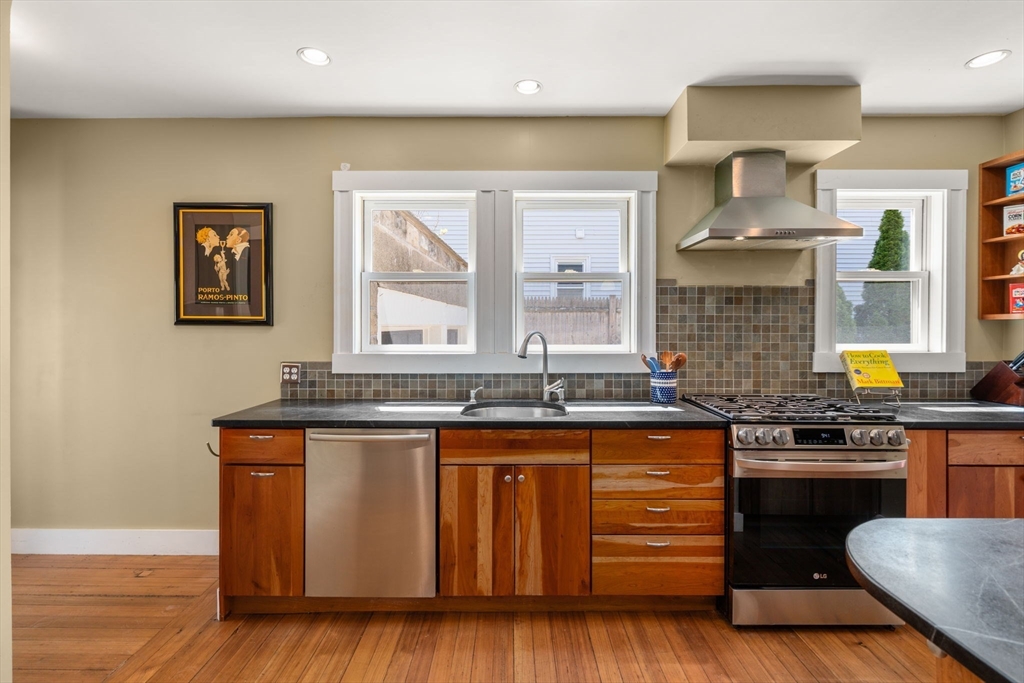 45 Springfield Street, Unit 1 Belmont, MA 02478 - Photo 10 of 27 a kitchen with stainless steel appliances granite countertop wooden floors and sink