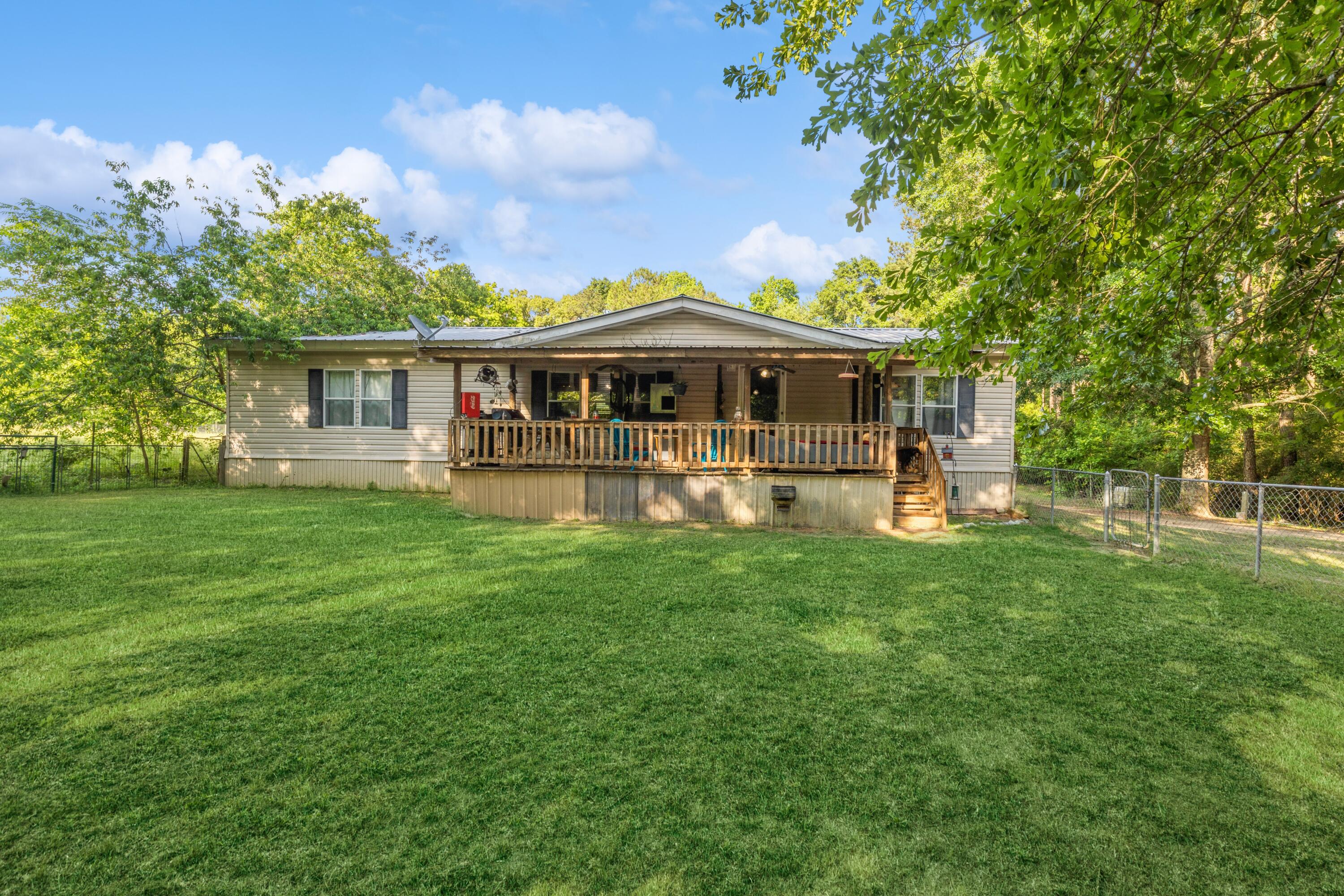 8495 Creston Barrow Road Baker, FL 32531 - Photo 1 of 35 a front view of house with yard and green space