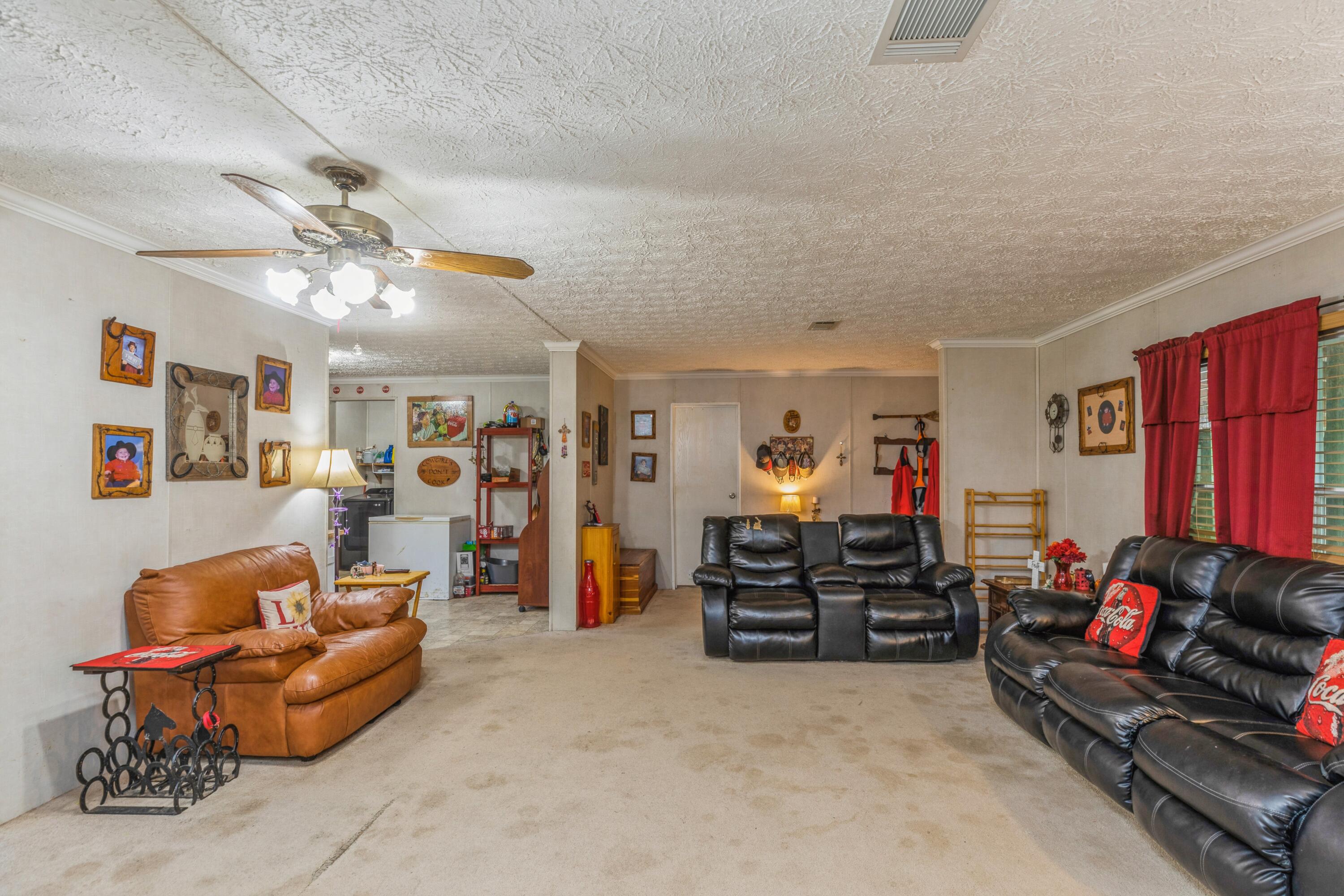 8495 Creston Barrow Road Baker, FL 32531 - Photo 12 of 35 a living room with furniture and a flat screen tv