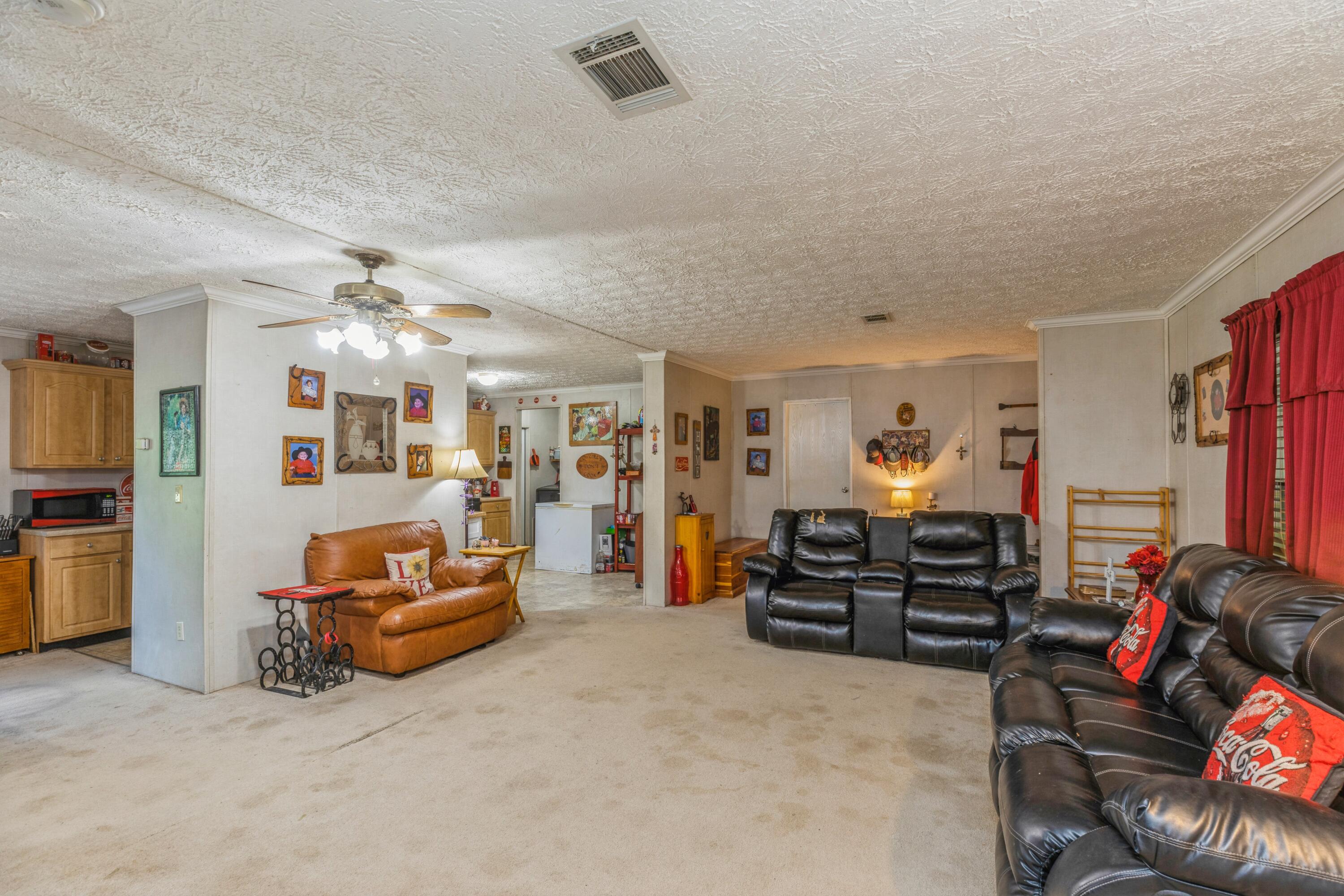 8495 Creston Barrow Road Baker, FL 32531 - Photo 13 of 35 a living room with furniture and a flat screen tv
