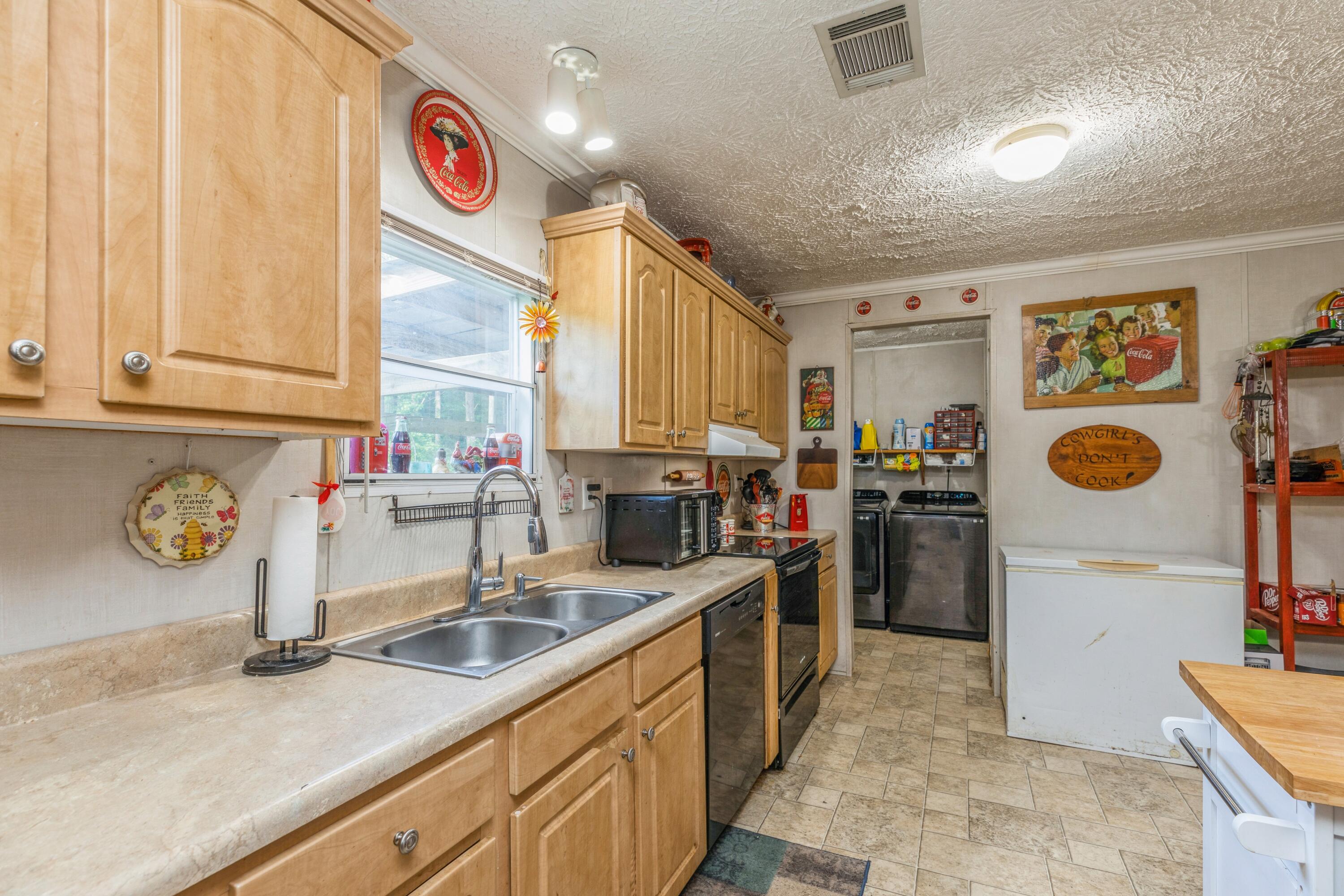 8495 Creston Barrow Road Baker, FL 32531 - Photo 14 of 35 a kitchen with refrigerator and window