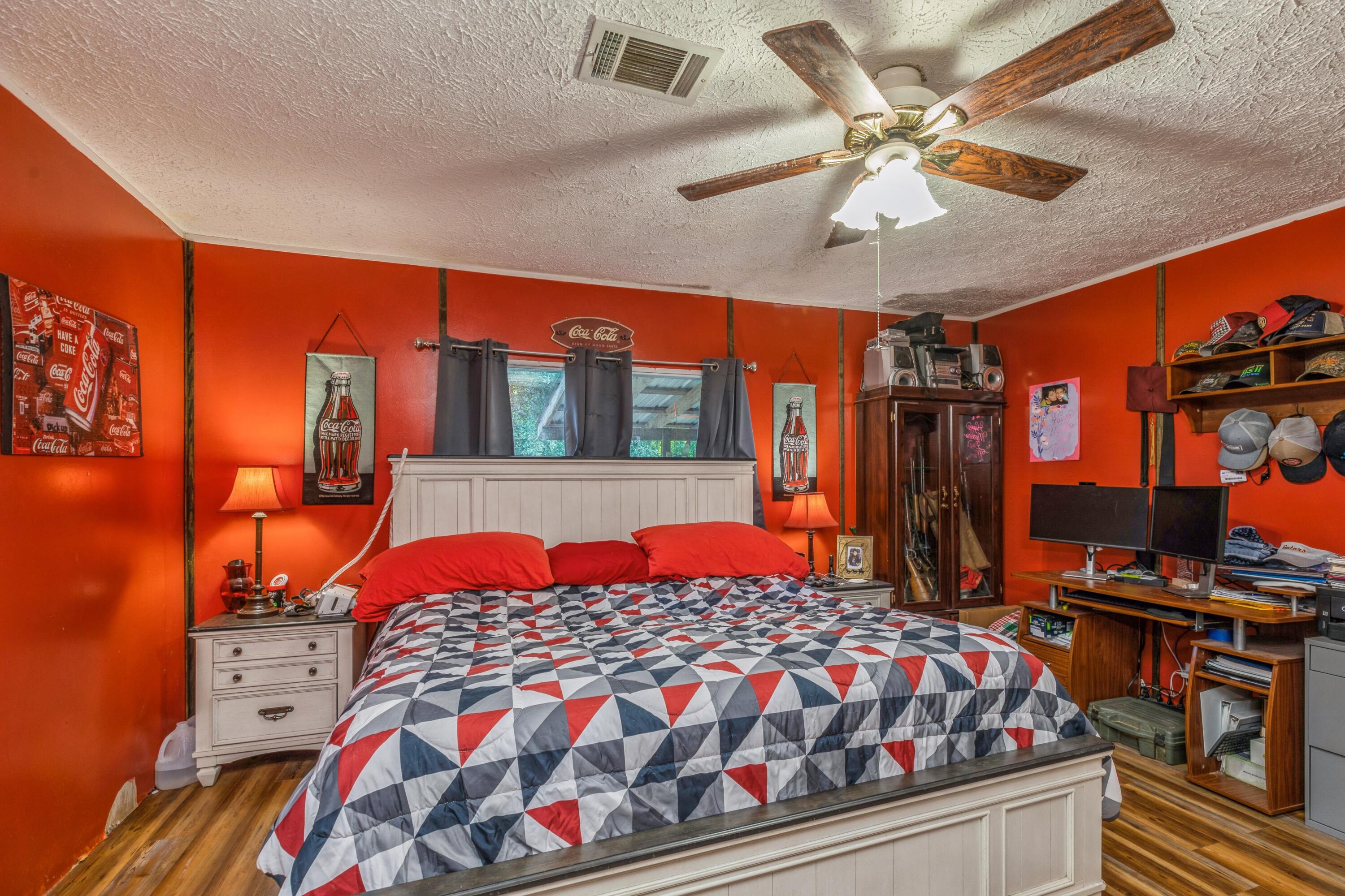 8495 Creston Barrow Road Baker, FL 32531 - Photo 20 of 35 a bedroom with a bed and dresser with the outer view