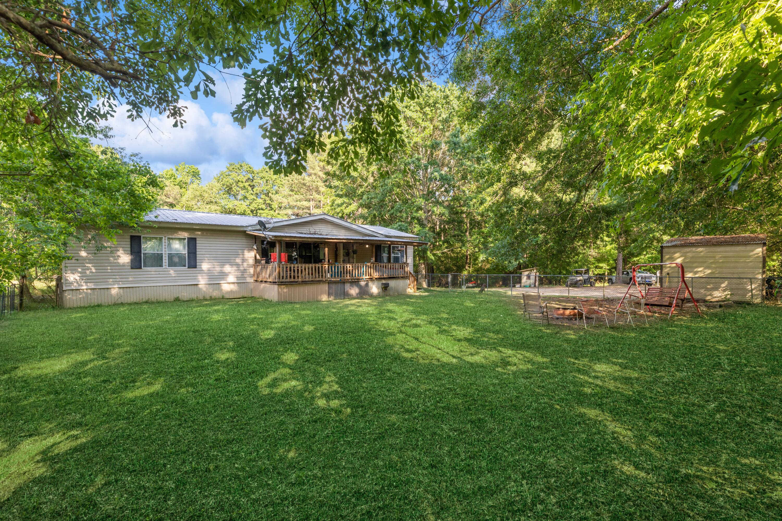 8495 Creston Barrow Road Baker, FL 32531 - Photo 2 of 35 a front view of a house with a garden