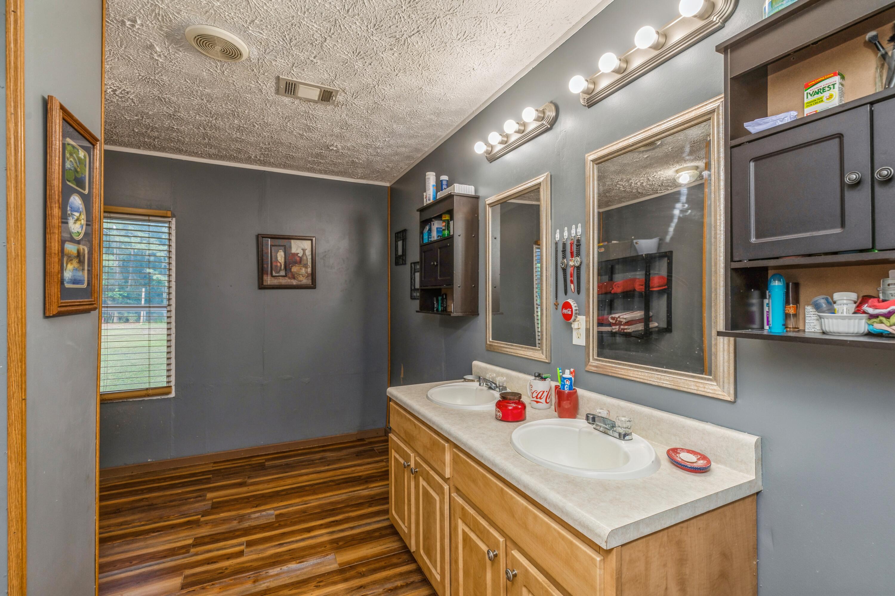 8495 Creston Barrow Road Baker, FL 32531 - Photo 22 of 35 a bathroom with a sink vanity and mirror