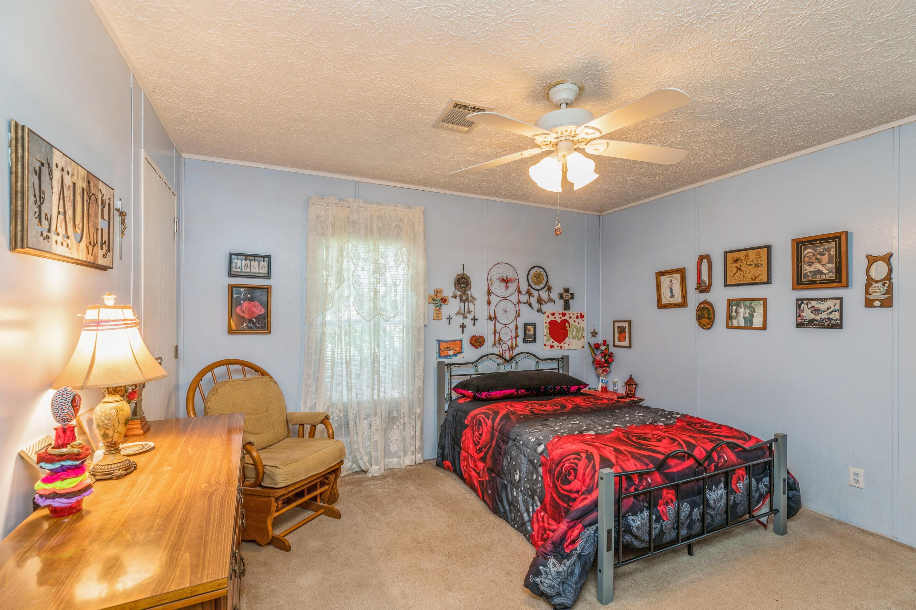 8495 Creston Barrow Road Baker, FL 32531 - Photo 24 of 35 a bedroom with a bed and a chandelier
