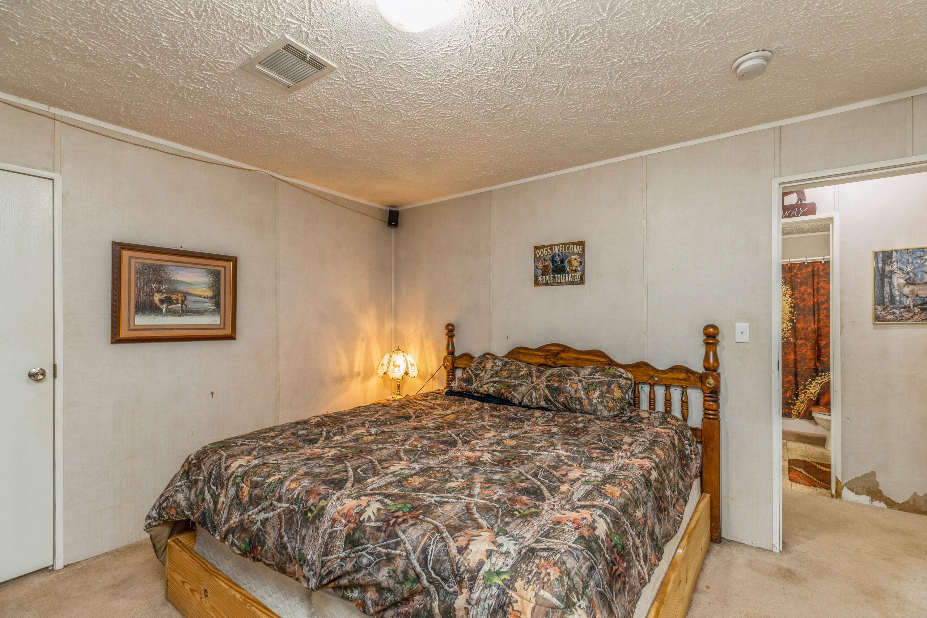 8495 Creston Barrow Road Baker, FL 32531 - Photo 26 of 35 a bedroom with a bed and a cabinets