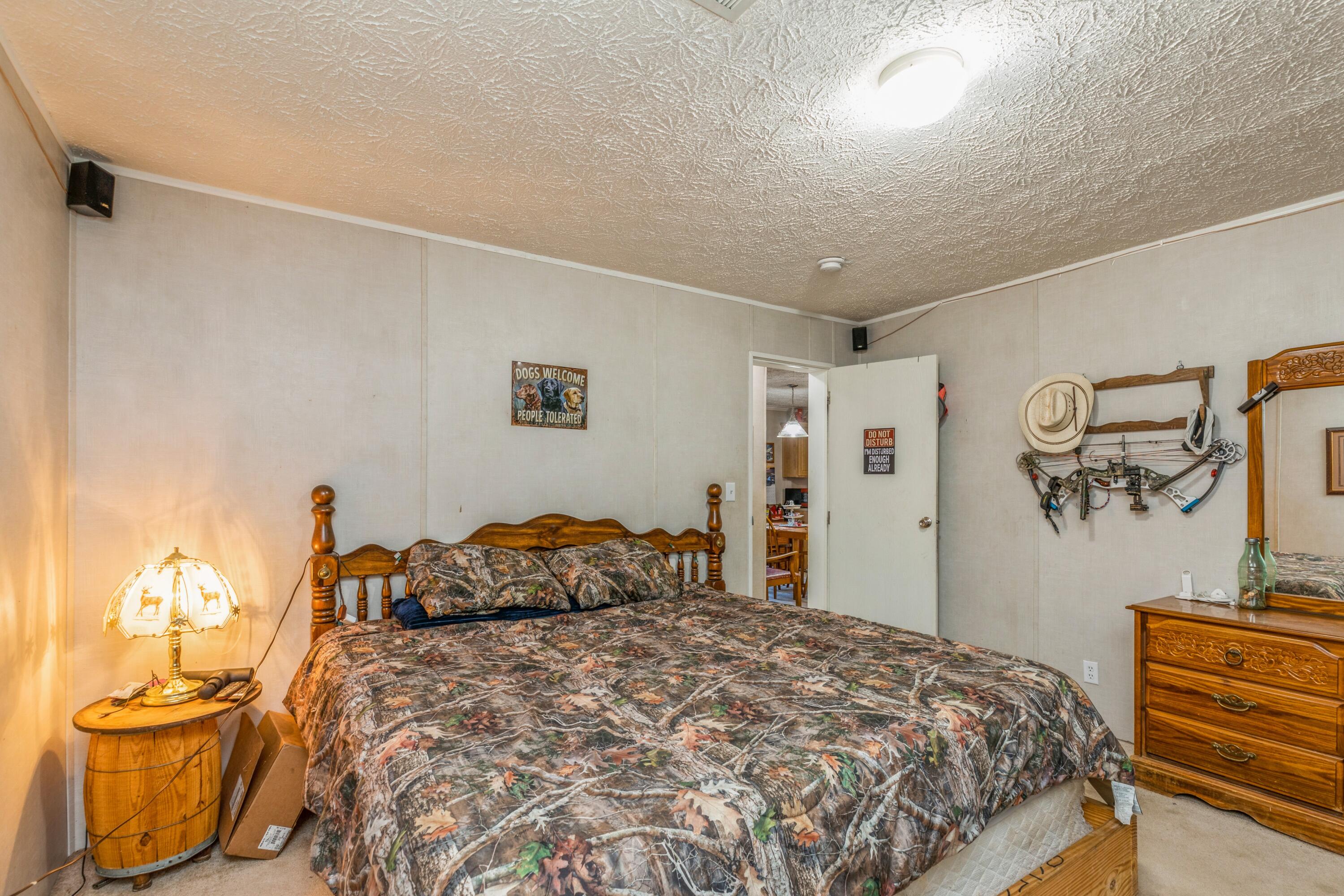 8495 Creston Barrow Road Baker, FL 32531 - Photo 27 of 35 a bedroom with a bed and a cabinets
