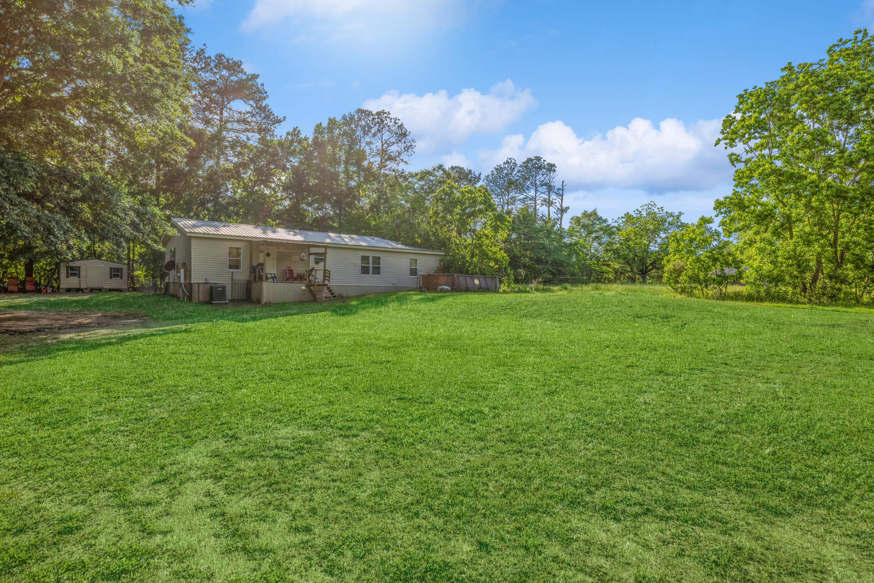 8495 Creston Barrow Road Baker, FL 32531 - Photo 31 of 35 a view of a house with a big yard and large trees