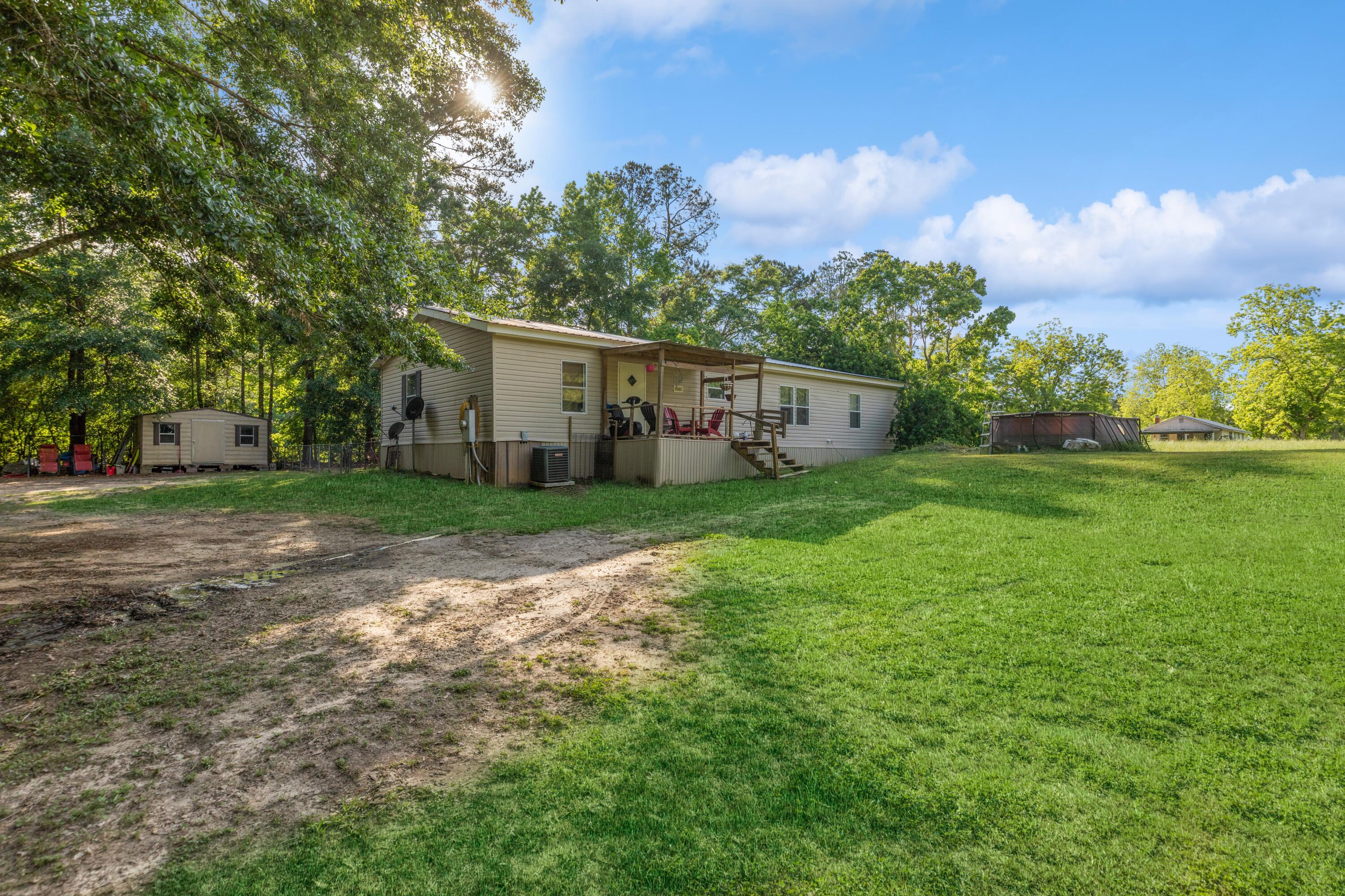 8495 Creston Barrow Road Baker, FL 32531 - Photo 35 of 35 a view of a house with backyard and trees