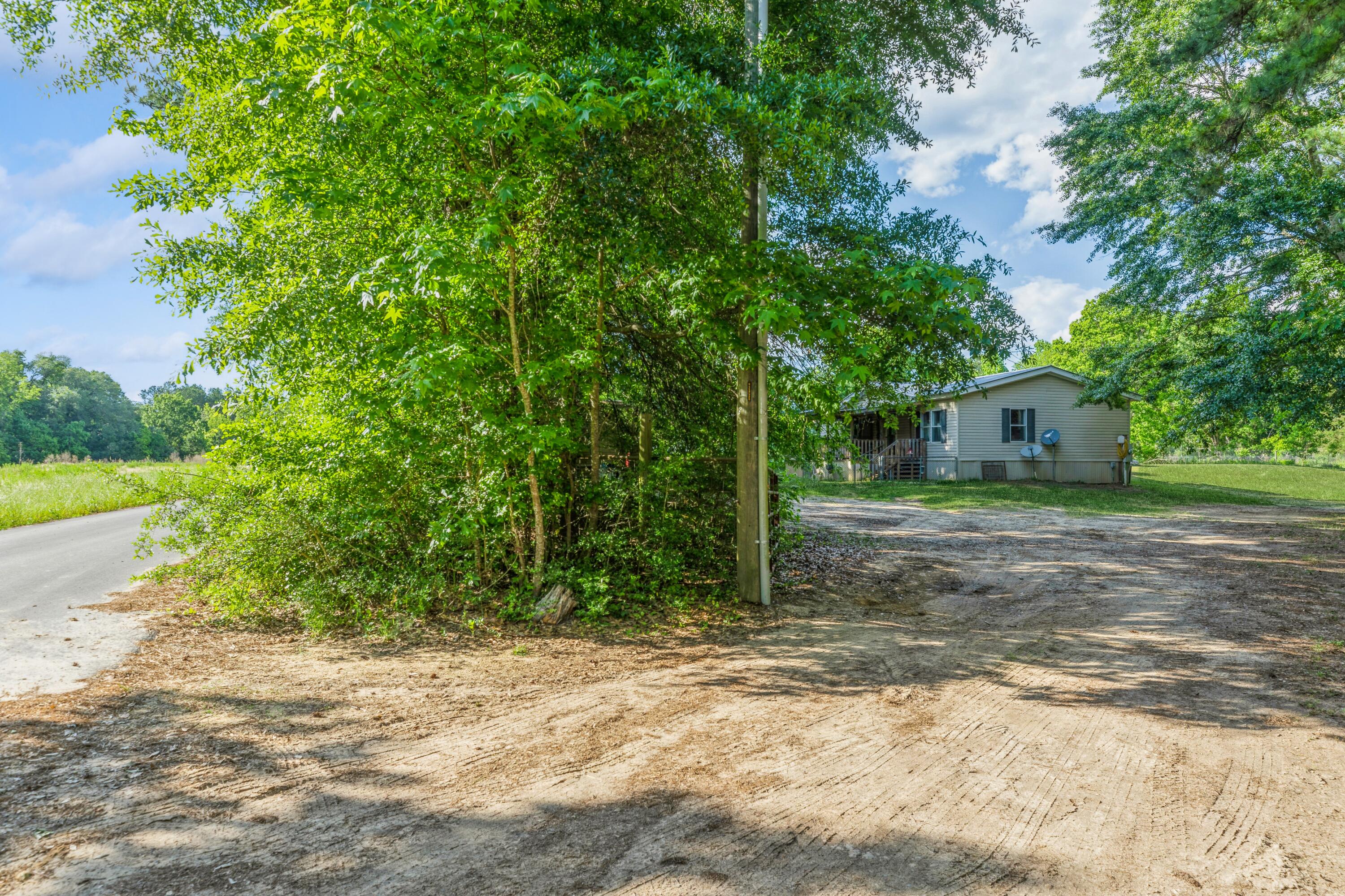 8495 Creston Barrow Road Baker, FL 32531 - Photo 5 of 35 a house with trees in the background