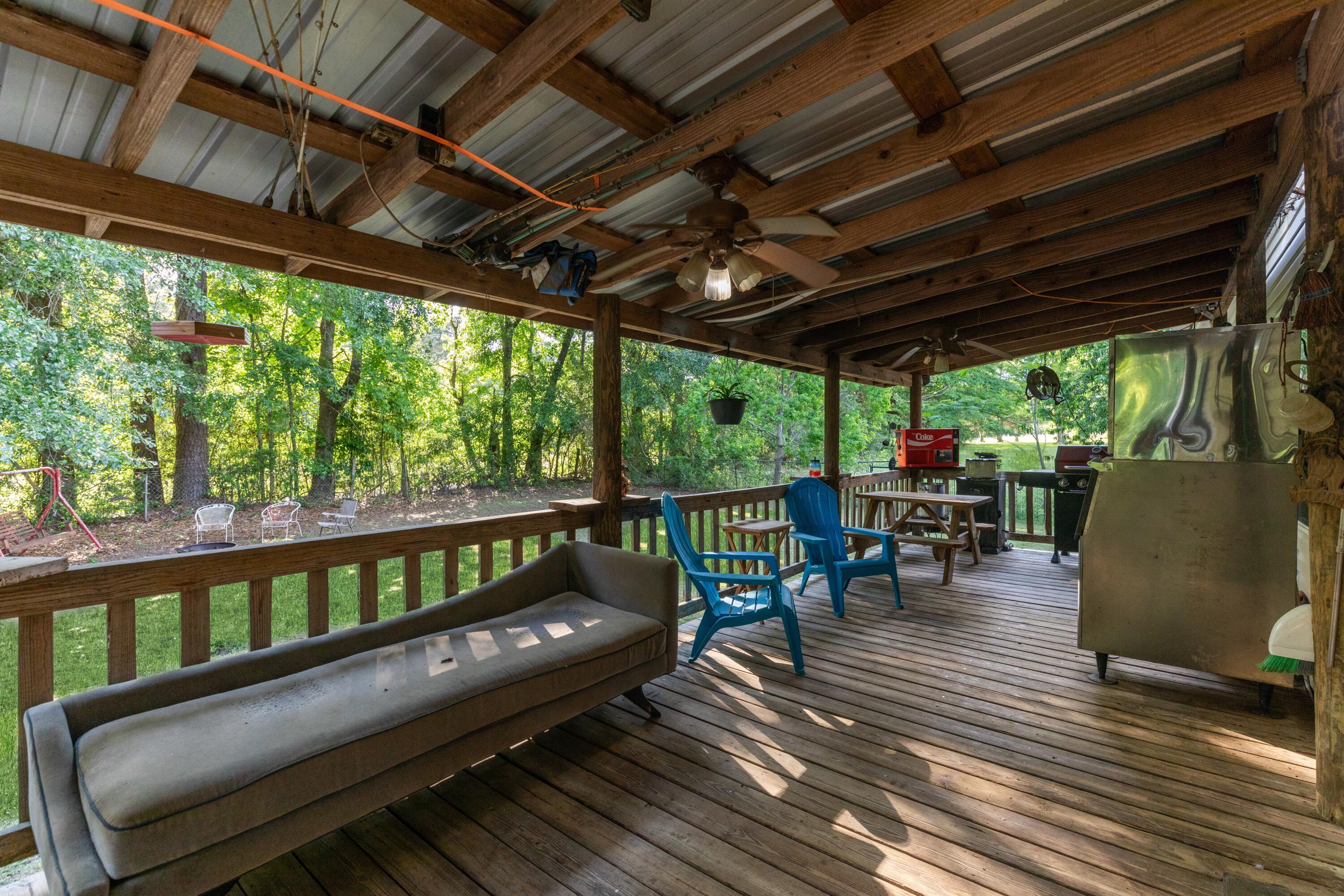 8495 Creston Barrow Road Baker, FL 32531 - Photo 7 of 35 a balcony with wooden floors and outdoor seating