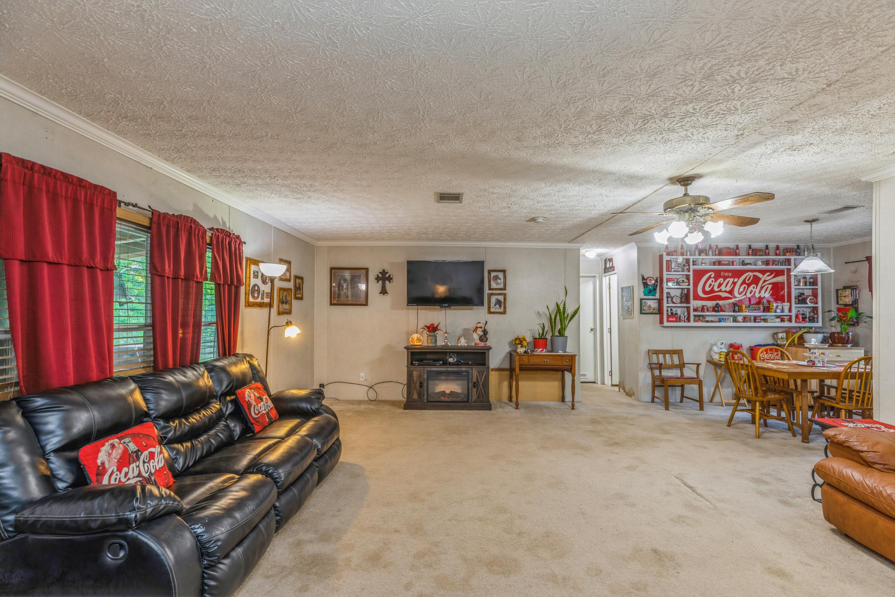 8495 Creston Barrow Road Baker, FL 32531 - Photo 8 of 35 a living room with furniture and a flat screen tv