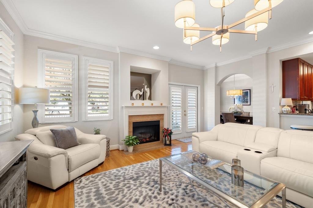 291 1st Avenue Southwest Largo, FL 33770 - Photo 15 of 83 a living room with furniture a fireplace and a chandelier