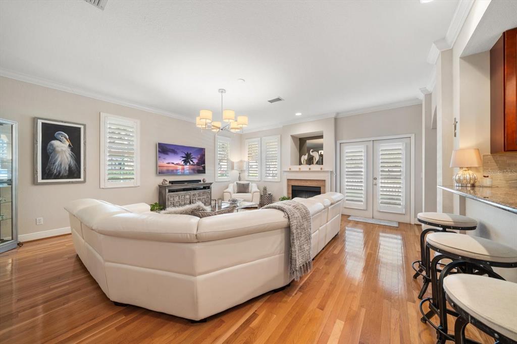 291 1st Avenue Southwest Largo, FL 33770 - Photo 19 of 83 a living room with furniture flat screen tv and wooden floor