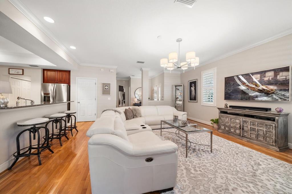 291 1st Avenue Southwest Largo, FL 33770 - Photo 22 of 83 a living room with furniture a flat screen tv and a chandelier