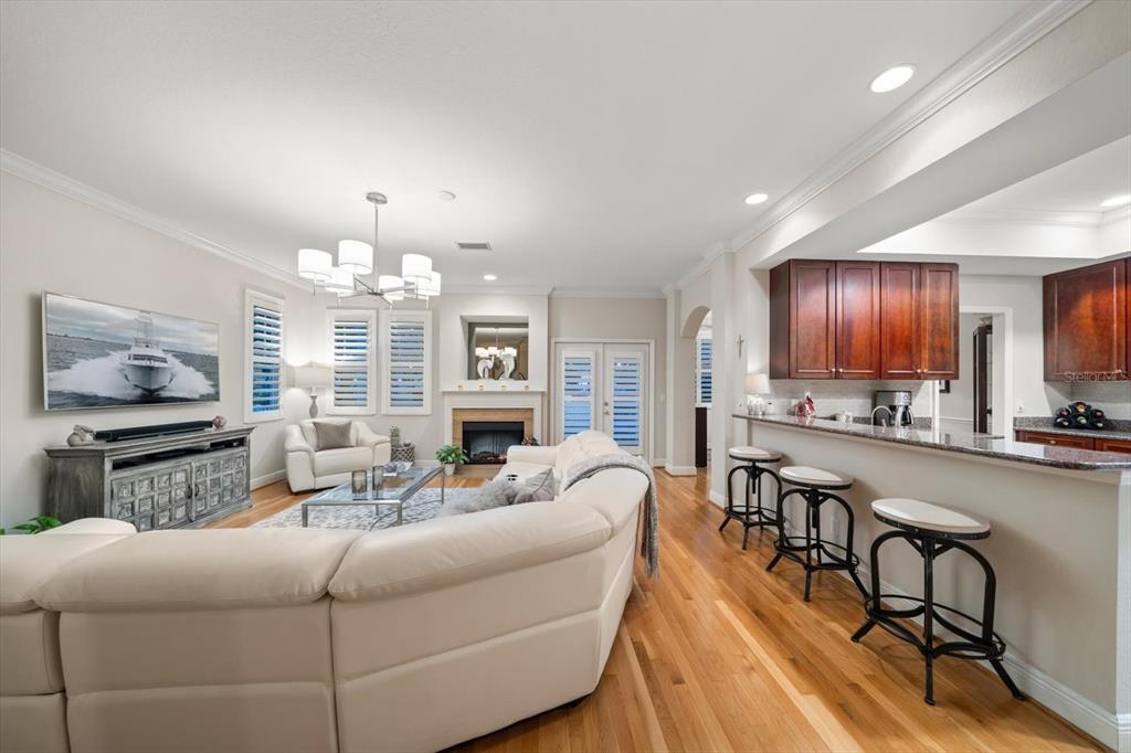 291 1st Avenue Southwest Largo, FL 33770 - Photo 25 of 83 a living room with furniture a chandelier and kitchen view