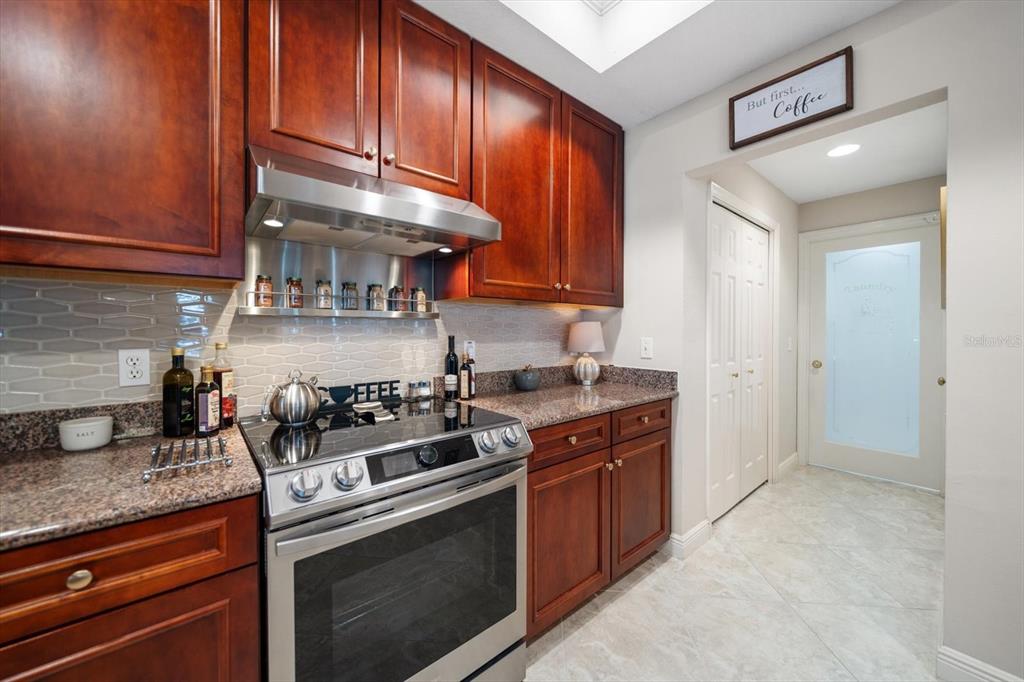 291 1st Avenue Southwest Largo, FL 33770 - Photo 29 of 83 a kitchen with stainless steel appliances granite countertop a stove and a sink