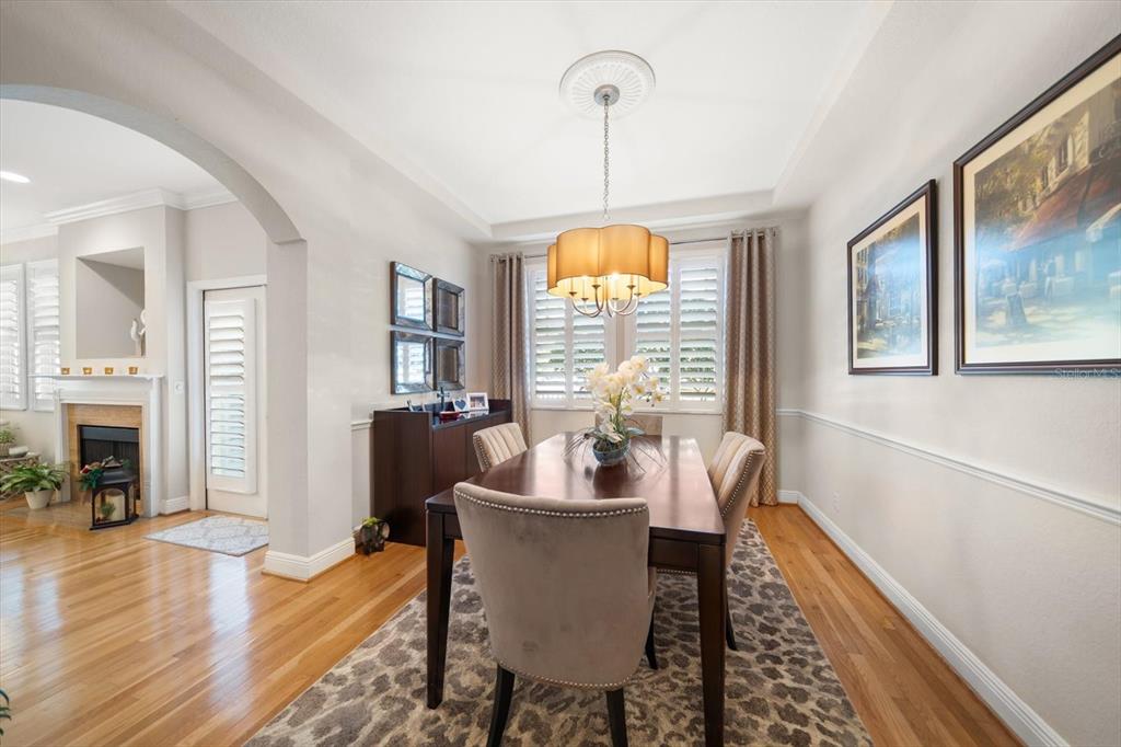 291 1st Avenue Southwest Largo, FL 33770 - Photo 33 of 83 a dining room with furniture a chandelier and wooden floor