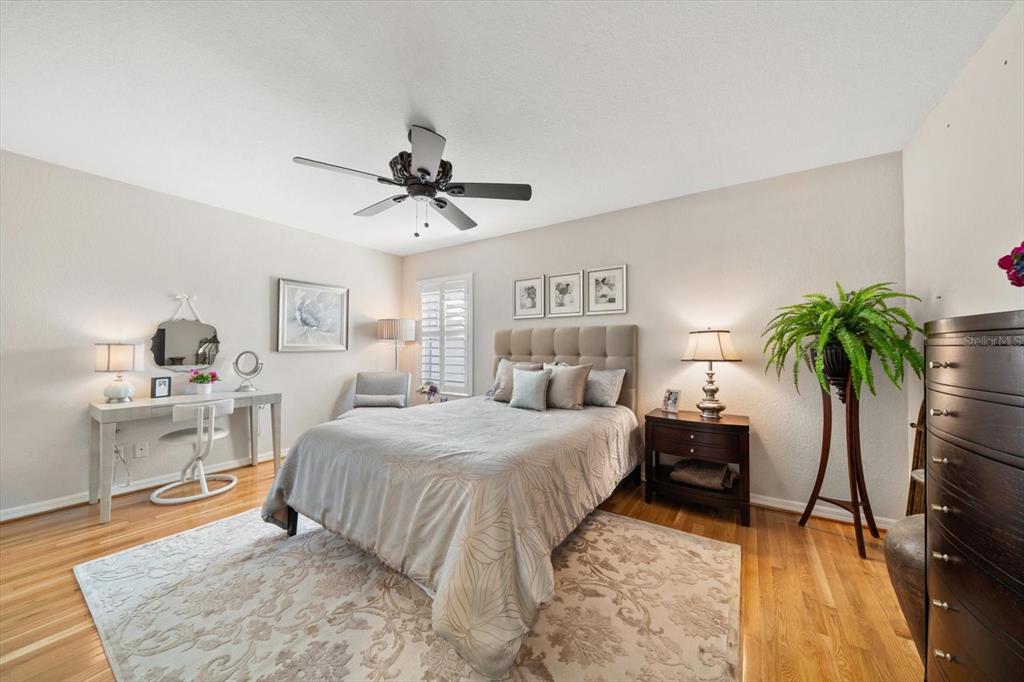 291 1st Avenue Southwest Largo, FL 33770 - Photo 39 of 83 a bedroom with a bed and a table with potted plants