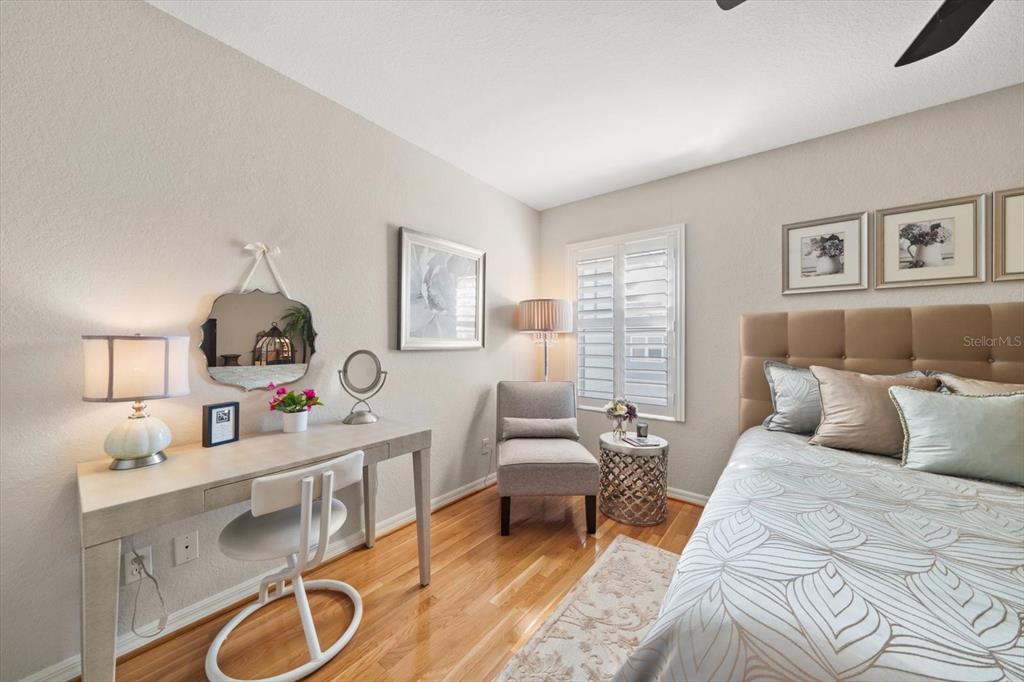 291 1st Avenue Southwest Largo, FL 33770 - Photo 41 of 83 a bedroom with a bed a mirror and lamp next to a window