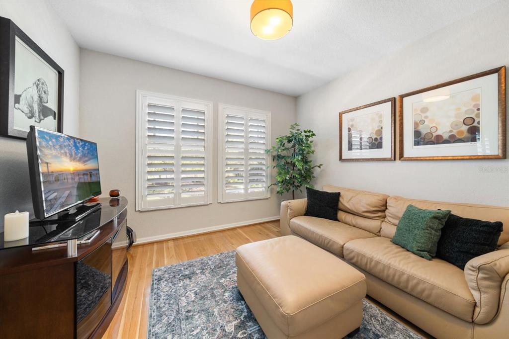 291 1st Avenue Southwest Largo, FL 33770 - Photo 47 of 83 a living room with furniture and a flat screen tv