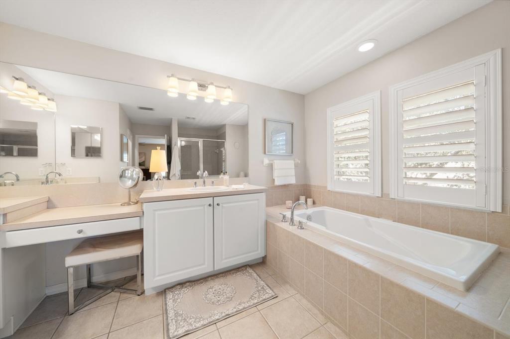 291 1st Avenue Southwest Largo, FL 33770 - Photo 50 of 83 a bathroom with a tub a sink and a mirror