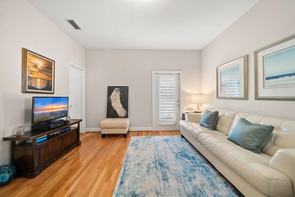 291 1st Avenue Southwest Largo, FL 33770 - Photo 56 of 83 a living room with furniture and a flat screen tv