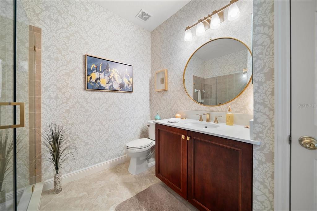291 1st Avenue Southwest Largo, FL 33770 - Photo 58 of 83 a bathroom with a toilet a sink and a mirror