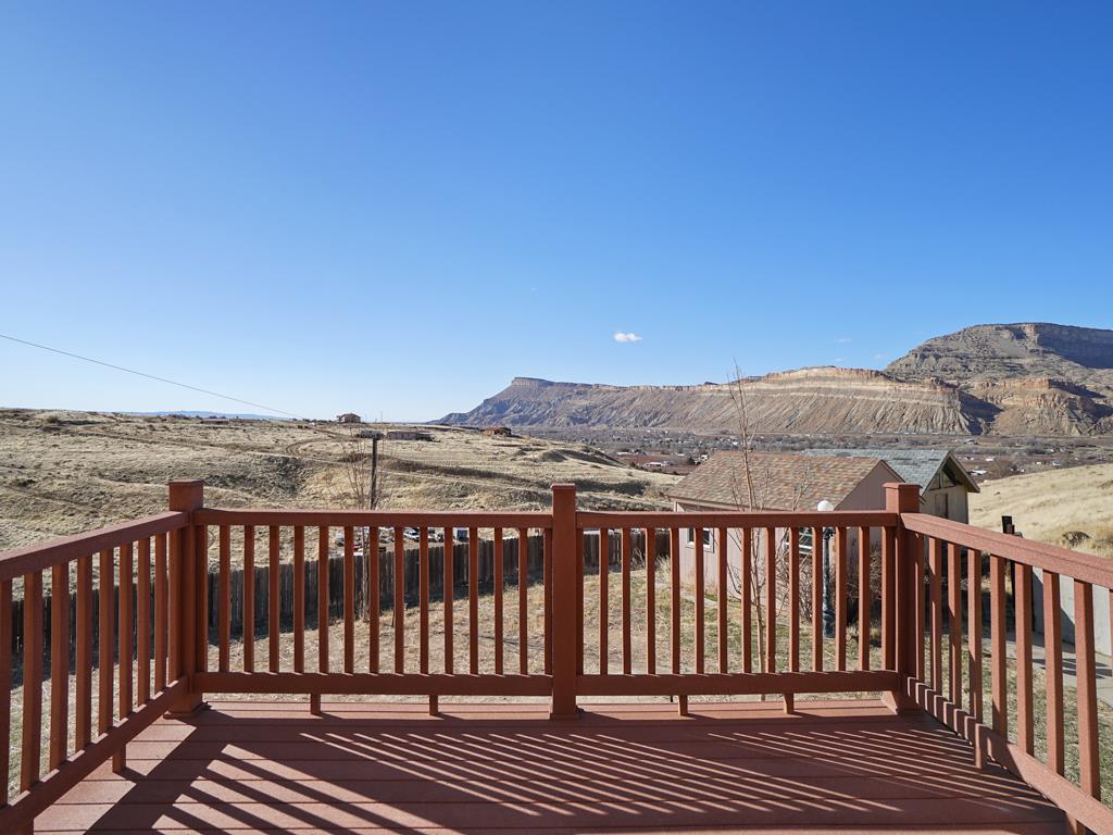 653 39 Road Palisade, CO 81526 - Photo 12 of 35 a view of a balcony with wooden floor and city view