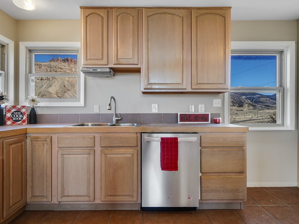 653 39 Road Palisade, CO 81526 - Photo 15 of 35 a kitchen with stainless steel appliances granite countertop a sink and cabinets