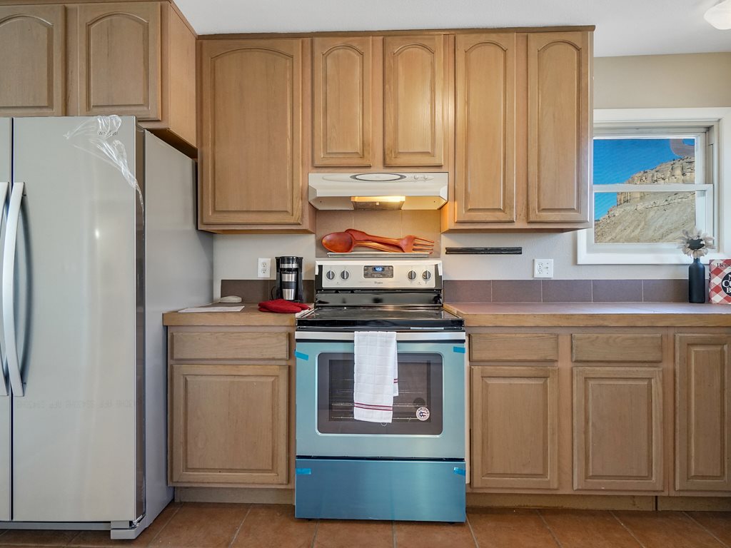 653 39 Road Palisade, CO 81526 - Photo 16 of 35 a kitchen with stainless steel appliances granite countertop a refrigerator and a stove
