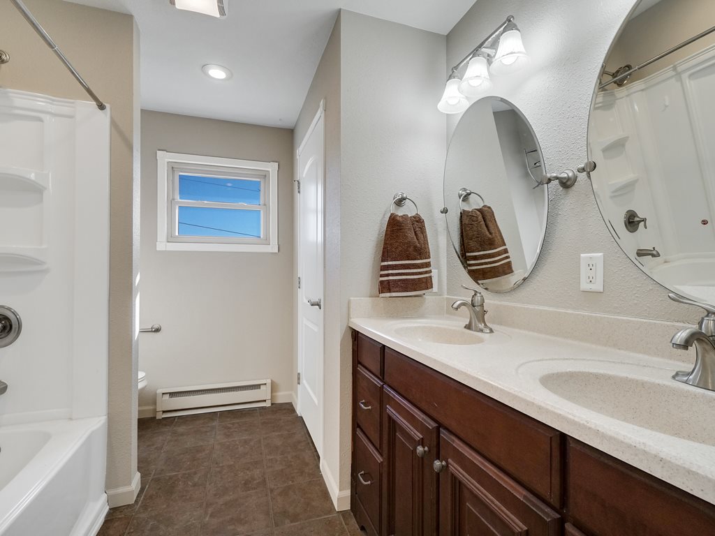 653 39 Road Palisade, CO 81526 - Photo 19 of 35 a bathroom with a sink double vanity granite tub shower and a mirror