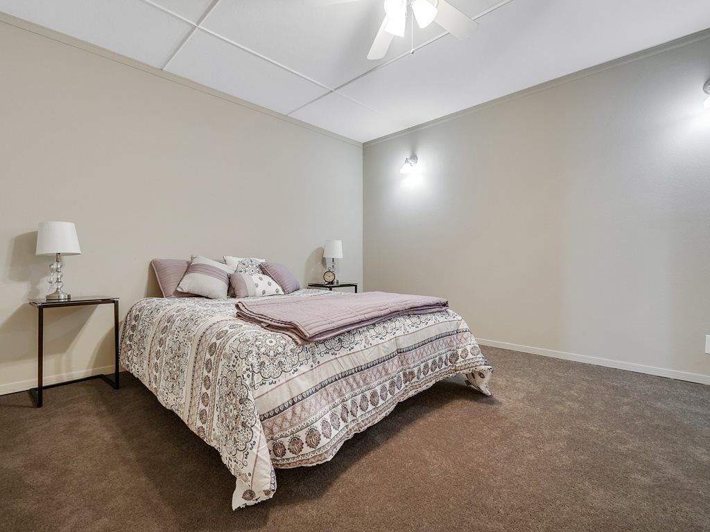 653 39 Road Palisade, CO 81526 - Photo 21 of 35 a bedroom with a bed and lamp with window