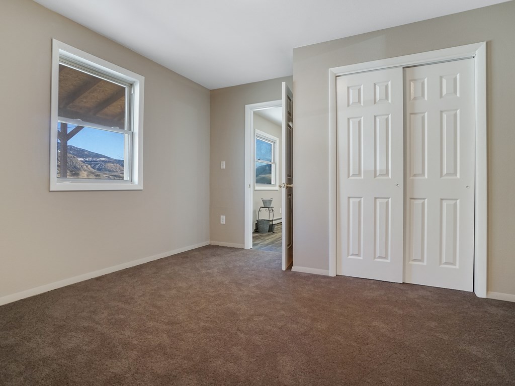 653 39 Road Palisade, CO 81526 - Photo 23 of 35 an empty room with windows and closet