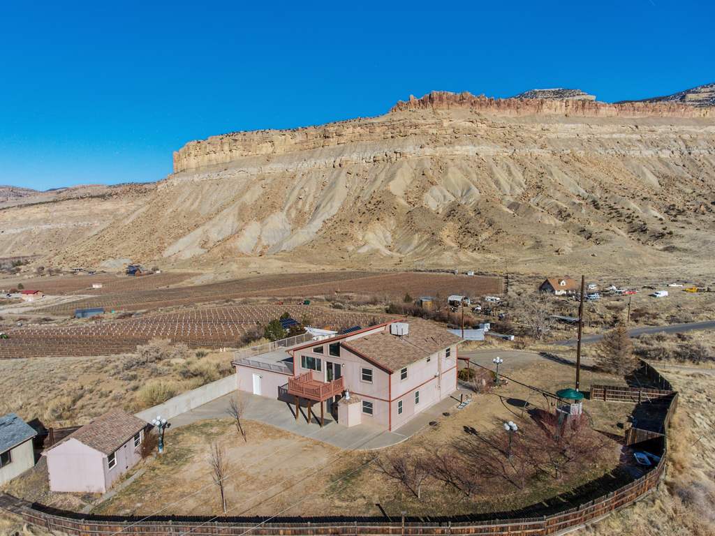 653 39 Road Palisade, CO 81526 - Photo 3 of 35 a view of a ocean with a mountain in the background